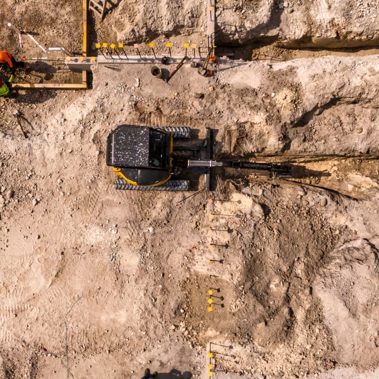 aerial view of an excavator working at a dig site