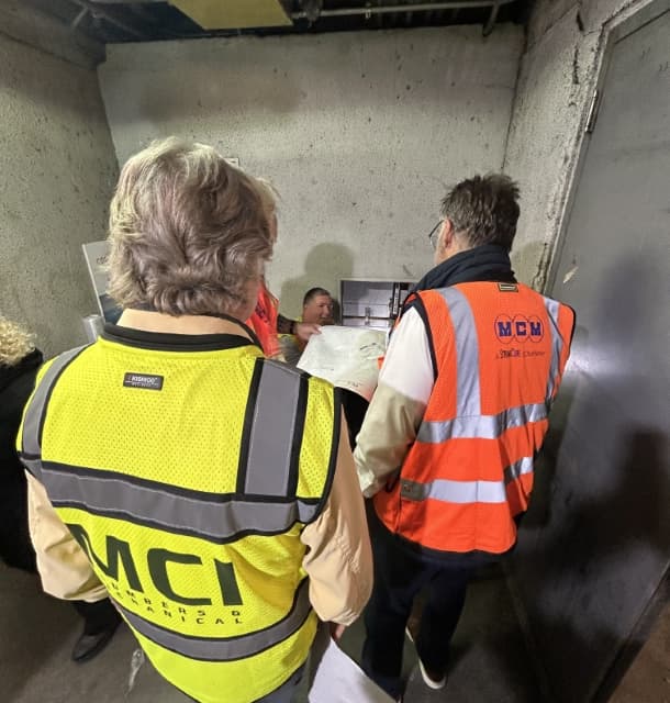 MCI and MCM project staff reviewing drawings on site at Miami International Airport